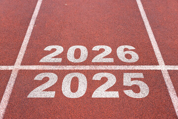 Start of new year. Changes of year 2025, 2026, 2027 on Running track. Concept of new ideas starting in new year, planning along with setting objectives to set KPI goals for success in life.
