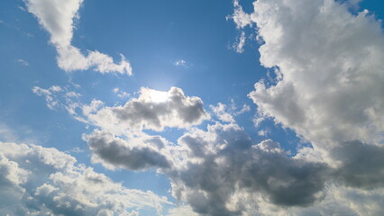 A stunning view of a beautifully cloudy sky illuminated by the soft, warm sunlight above