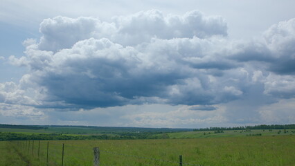 Dramatic Cloudscapes Frame a Lush Green Landscape As Daylight Shines Down Upon It
