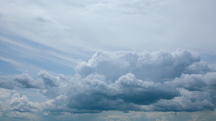A Dramatic Cloudscape Set Against a Bright Blue Sky, Evoking a Sense of Wonder and Calmness