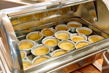 Deliciously Baked Mini Custards Served in Metal Dishes, Perfect for Any Dessert Table Display at a...