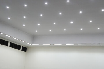 Modern Room Interior with Recessed Lighting and Air Vents.
