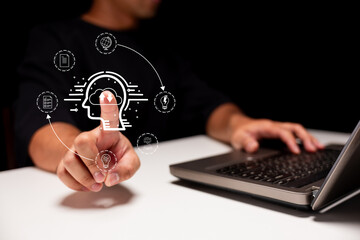 A person interacts with a digital interface using their finger, surrounded by icons representing ideas and information.