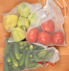 A top-down shot of various vegetables including tomatoes, peppers, and cucumbers, packed in...