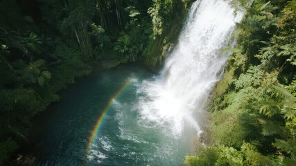 Aerial View of a Lush Jungle Waterfall with a Rainbow
