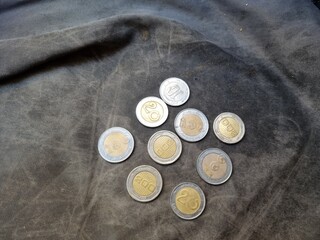 A pile of Algerian money with a black background