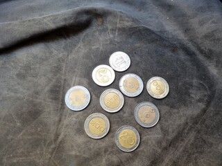 A pile of Algerian money with a black background