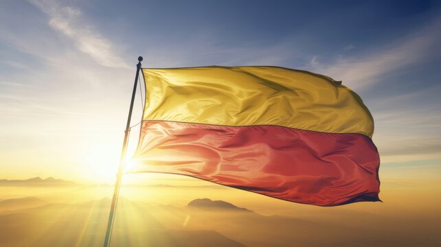 Karnataka flag waving in the wind against a beautiful sunrise sky