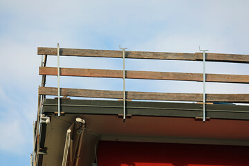 safety barrier with wooden boards during maintenance work on the roof of the condominium