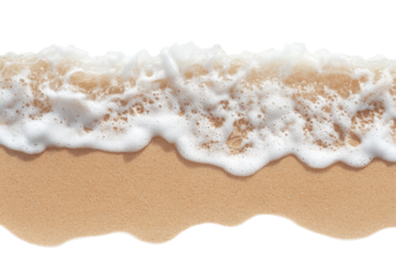 Ocean wave washing onto sandy beach isolated on transparent background. Top view of ocean waves gently lapping onto a sandy beach creating a serene coastal scene isolated on white background.