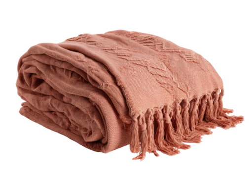 Folded, coral-colored blanket with textured design and fringe