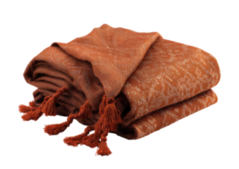 Folded terracotta-colored throw blanket with a subtle, patterned design and tassels