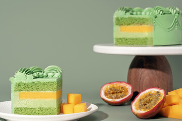 Vibrant bento cake featuring layers of mango and passion fruit, adorned with pistachio sponge,...