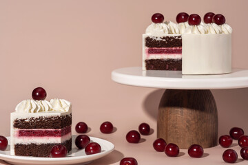 Bento cake with layers of chocolate, cherry filling, and whipped cream, beautifully presented on a...