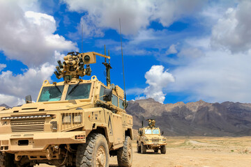 Military Vehicles on Patrol in a Desert Terrain for Security Operations