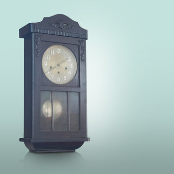 Antique and old brown and black color wall clock on gradient white and green background, object, technology, decor, ancient, old, fashion, copy space