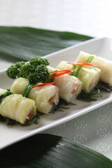 Light cabbage rolls stuffed with fiber-rich enoki mushrooms and fresh greens. A healthy Korean dish by Master Chef Hanshunseop. Photographed in Korea.