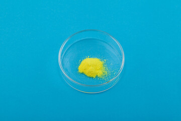 Powder of furacilin or nitrofural powder in Petri dish. Disinfectant, antiseptic has a bactericidal effect. Yellow powder with chemical formula C6H6N4O4