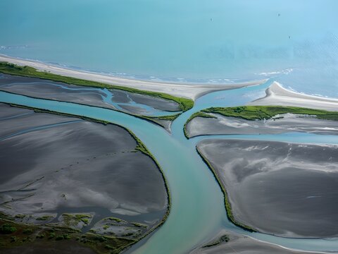 Fototapeta Aerial view of stunning river delta meeting the ocean, peaceful coastal scene