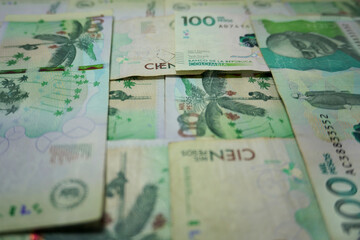 Concepts about Colombian money. 100000 Colombian pesos banknotes background