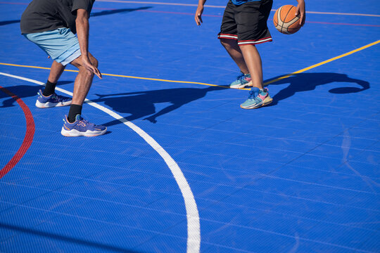 Man seen dribbling basketball with defender