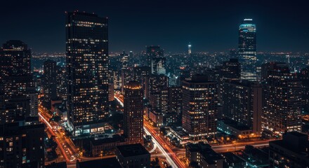 Naklejka premium Illuminated city skyline at night with vibrant streetlights and towering skyscrapers