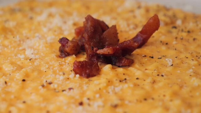 Risotto carbonara texture, delicious twist on the famous first course made with egg yolks, pecorino, and guanciale. High quality 4k footage