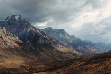 Mountain range panorama, autumnal colors, dramatic clouds