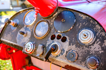 Old tractor parked under a clear blue sky in a rural setting, showcasing its weathered beauty and classic design during the sunny afternoon
