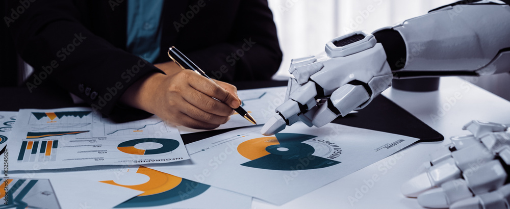 Poster a human hand writing notes alongside a robotic hand, reflecting the integration of technology into b
