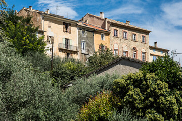 typical houses build on a rock in the little village of Saint-Julien-d'Asse in the French Verdon region under a blue sky in summer