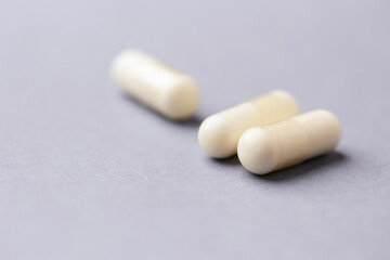 Amino acids capsules on bright background. Soft focus. Close up. Copy space.	