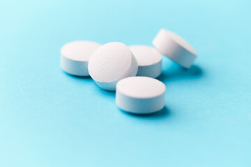 Creatine tablets on paper background. Soft focus. Close up. Copy space.