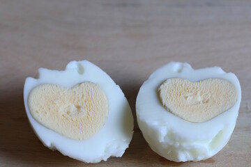 Chicken egg with heart shaped yolk.