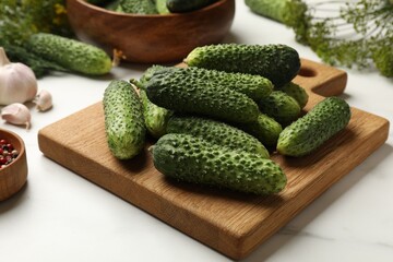 Making pickles. Fresh cucumbers on white table, closeup