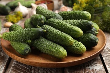 Making pickles. Fresh cucumbers and spices on wooden table, closeup