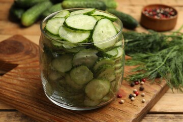 Making pickles. Fresh cucumbers and other ingredients on wooden table, closeup