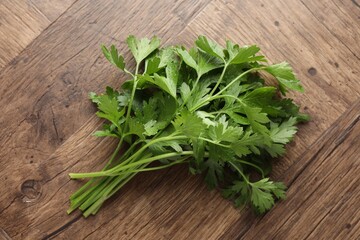 Fresh aromatic parsley on wooden table, top view