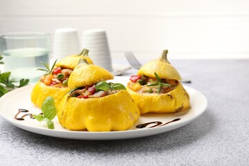 Tasty stuffed pattypan squashes on grey table, closeup