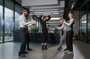 A group of people are dancing in a room