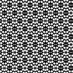 Seamless black and white geometric pattern with abstract floral and star motifs. Vector graphic background design.