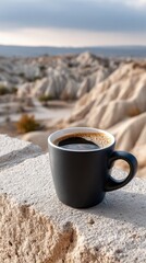 A black coffee mug sits on a wooden surface at the edge of an alien planet, showcasing mountains and deserts in bright light