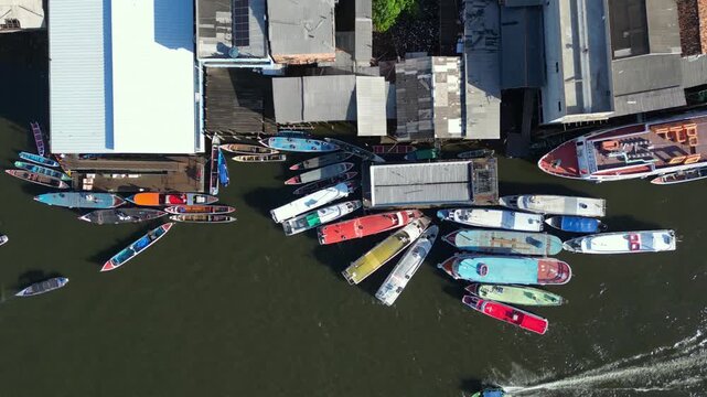 Aerial drone video showing boat traffic along the waterfront of Cameta, a historic city on the banks of the Tocantins river in Para state, Brazil