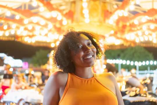 Smiling woman enjoying a festive carousel ride