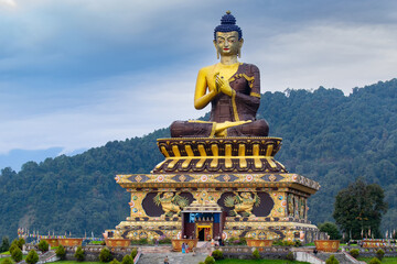 Fototapeta premium Beautiful huge statue of Lord Buddha, at Rabangla , Sikkim , India. Surrounded by Himalayan Mountains, it is called Buddha Park - a popular tourist attraction for tourists from all over India.
