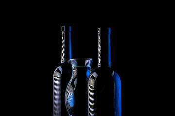 Still life with glass bottles on a dark background