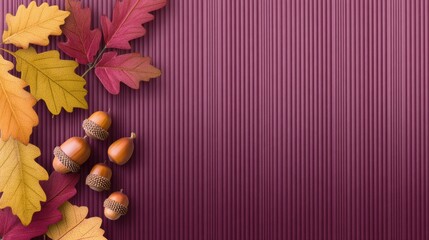 Autumn leaves and acorns arranged on a textured purple background, evoking seasonal change and warmth