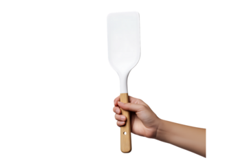 Kitchen utensil spatula held in hand on transparent background. Cooking spatula tool held by hand isolated PNG.