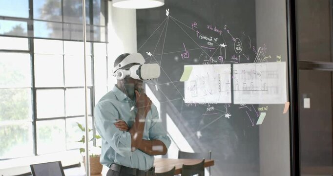 Engineer wearing VR headset studying holographic interface and starting dragging sticky note chart