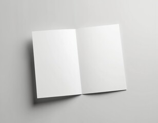 Open book lies flat on gray surface. Book pages are white with stark contrast to gray background. Text reads Open on right side. Book is centrally positioned with simple, clean design.